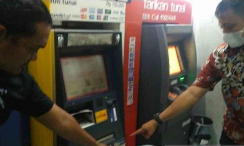 Polisi menunjukan mesin ATM Bank Mandiri